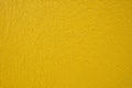 Shrunken yellow paint covered surface as background Royalty Free Stock Photo