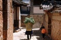 Shu He, China: Woman with Straw Basket Royalty Free Stock Photo