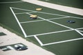 Shuffleboard court with pucks on the board Royalty Free Stock Photo