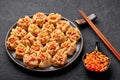 Shumai or Kanom Jeeb or Steamed Pork and Shrimp Dumplings on a black plate on dark slate backdrop. Chinese food. Asian Meal