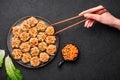 Shumai or Kanom Jeeb or Steamed Pork and Shrimp Dumplings on a black plate on dark slate backdrop. Chinese food. Asian Meal