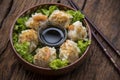 Shumai shrimp with sauce, Steamed shrimp dumplings dim or dim sum and vegetable on wooden table, Cantonese Dimsum food cuisine for Royalty Free Stock Photo