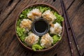 Shumai shrimp with sauce, Steamed shrimp dumplings dim or dim sum and vegetable on wooden table, Cantonese Dimsum food cuisine for Royalty Free Stock Photo