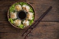 Shumai shrimp with sauce, Steamed shrimp dumplings dim or dim sum and vegetable on wooden table, Cantonese Dimsum food cuisine for Royalty Free Stock Photo