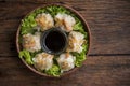 Shumai shrimp with sauce, Steamed shrimp dumplings dim or dim sum and vegetable on wooden table, Cantonese Dimsum food cuisine for Royalty Free Stock Photo