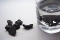 The shungite stones in a glass of water.