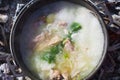 Shurpa soup in a large cast-iron cauldron outdoor. Summer food for hike. Top view. Royalty Free Stock Photo