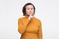 Shush, be silent concept. Serious female student asks to keep secret information confidential. Royalty Free Stock Photo
