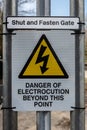 Danger of electrocution sign on a railway access gate Royalty Free Stock Photo
