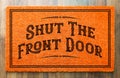 Shut the Front Door Orange Welcome Mat On Wood Floor Background Royalty Free Stock Photo