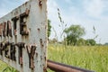 Shut and locked farm gate showing an improvised and rusting Private Property sign. Royalty Free Stock Photo