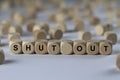 Shut out - cube with letters, sign with wooden cubes