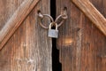 Locked steel padlock securing wooden doors Royalty Free Stock Photo