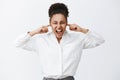 Shut up everybody. Portrait of intense distressed female african-american businesswoman in white shirt, shouting while