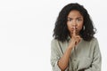 Shut up and listen. Portrait of intense displeased serious-looking african american woman shushing at camera with