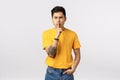 Shut your mouth. Aggressive serious-looking and displeased, strict young asian guy shushing, say shhh with angry face Royalty Free Stock Photo