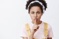 Shut your mouth. Studio shot of strict annoyed African American woman looking dangerious, saying shh while showing shush Royalty Free Stock Photo