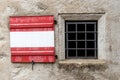 Shutter on the window of the castle wall in red and white like the Austrian flag Royalty Free Stock Photo
