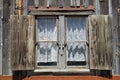 Shuttered window with locks and gray barn wood siding Royalty Free Stock Photo