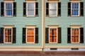 shuttered windows of the two-story colonial, close-up