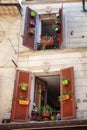 Shutters of a house in Antibes nicely decorated with colorful flower pots Royalty Free Stock Photo