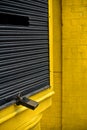 Shutters of shops closed yellow and black with padlock Royalty Free Stock Photo