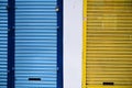 Shutters of shops closed yellow and blue