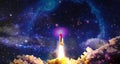 Shuttle launch in the clouds to outer space. Dark space with stars on background.Spaceship flight. Elements of this image