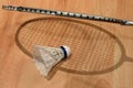 A shuttlecock with a badminton racket on the floor. Badminton game. Royalty Free Stock Photo