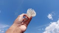 a photo of a person holding a shuttlecock against a bright blue sky as a background Royalty Free Stock Photo