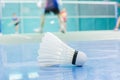 shuttlecock on the floor with badminton player Royalty Free Stock Photo
