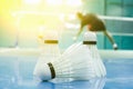 shuttlecock on the floor with badminton player Royalty Free Stock Photo