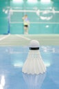 shuttlecock on the floor with badminton player Royalty Free Stock Photo