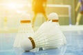 shuttlecock on the floor with badminton player Royalty Free Stock Photo