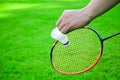 Shuttlecock holding by hand in front of the racket and ready to be served Royalty Free Stock Photo