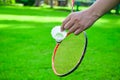 Shuttlecock holding by hand in front of the racket and ready to be served Royalty Free Stock Photo