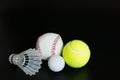 Shuttlecock, ping pong ball, baseball, tennis ball on black background Royalty Free Stock Photo