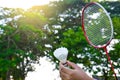 Shuttlecock racket going to hit the shuttlecock which holding by hand in front of the racket and ready to be served, soft and sele Royalty Free Stock Photo