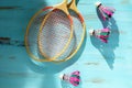 Shuttlecocks and badminton rackets on blue wooden background. Flat lay Royalty Free Stock Photo