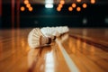 Shuttlecocks neatly placed on the polished wooden surface of a sports hall