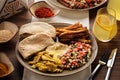 Shwarma in a plate with hummus and salad.