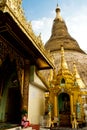 The Shwedagon Pagoda with a seated Buddhist nun, Yangon, Myanmar Royalty Free Stock Photo