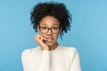 Shy awkward Afro woman wear glasses biting finger feeling embarrassed, confused and nervous. Studio