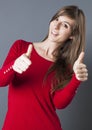 Shy beautiful young woman smiling with thumbs up