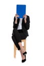Businesswoman hiding her face behind a blue clipboard Royalty Free Stock Photo