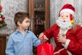 A shy child of several years receives a gift from Santa Claus.