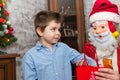 A shy child of several years receives a gift from Santa Claus.