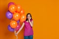 Shy and embarrassed woman with bright colorful air balloons