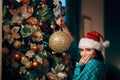 Funny Girl Decorating Christmas Tree and Laughing