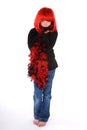 Shy girl in red wig and boa. Royalty Free Stock Photo